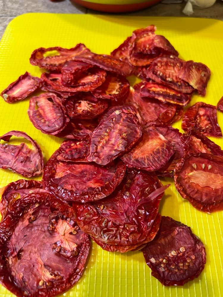 Bright dried tomatoes on a yellow mat