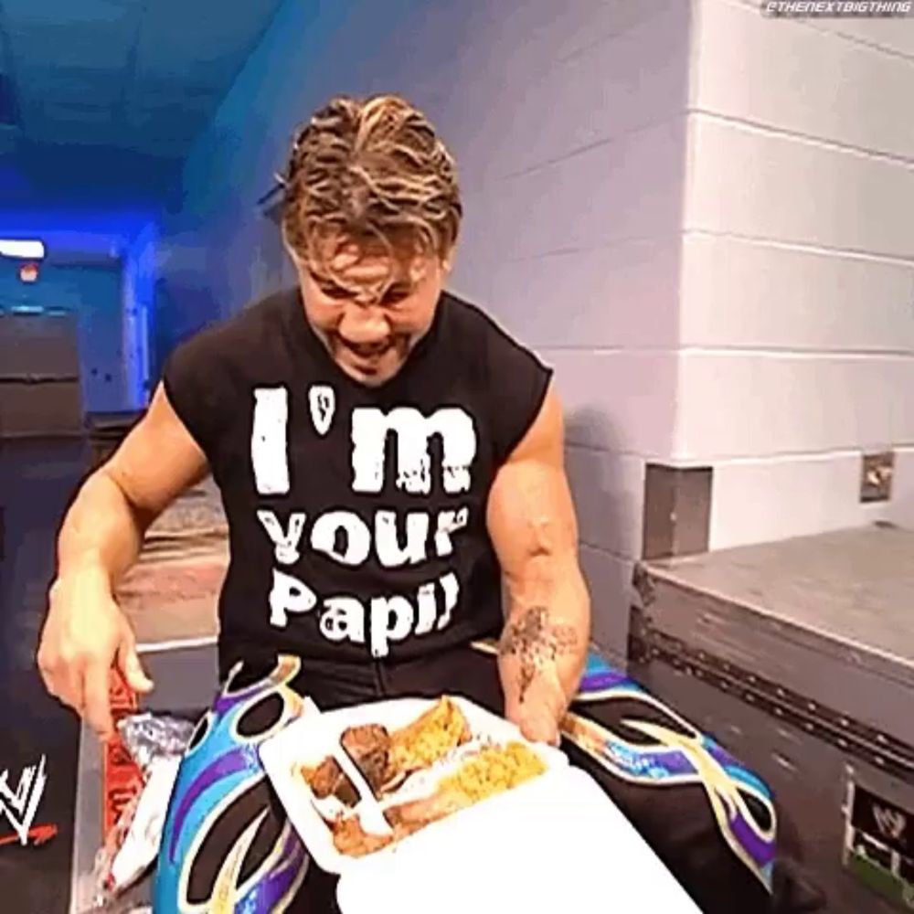 a man wearing a shirt that says " i 'm your papi " is eating food