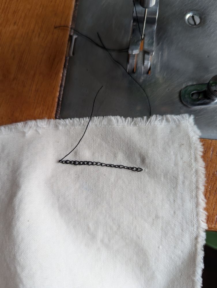 The underside of the same line of stitching, showing a chain of thread loops.