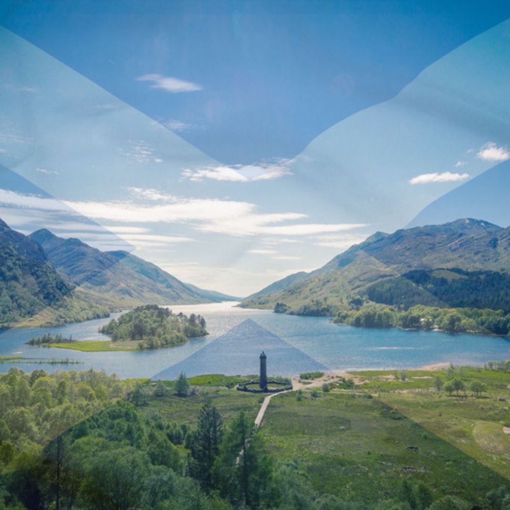 Photograph of the Glenfinnan Monument at Loch Shiel in the Scottish Highlands, superimposed over the Saltire. 