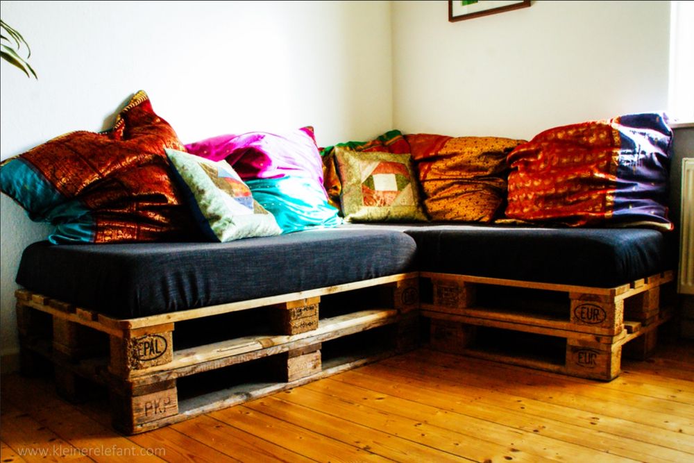 elegant sofa made out of pallets with lovely velvet cushions