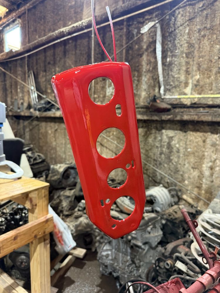 Jeep wrangler main parking brake cable bracket painted red. This one goes under the car and holds all the cables in place. 