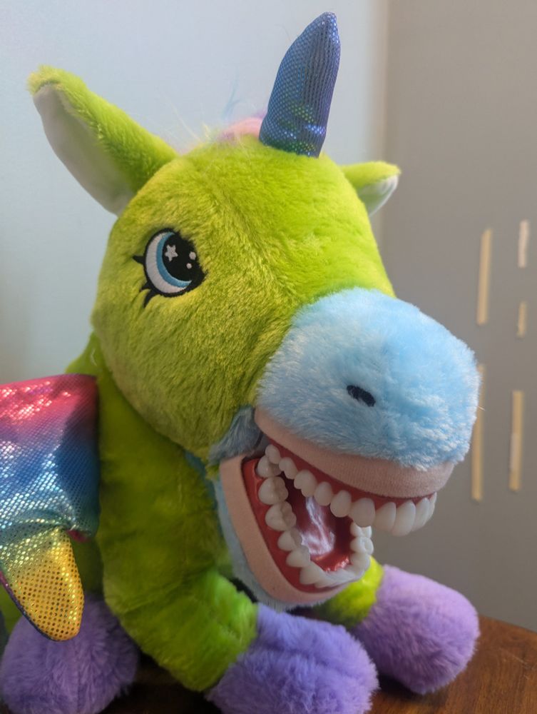 Disturbing unicorn stuffed animal with human teeth.
