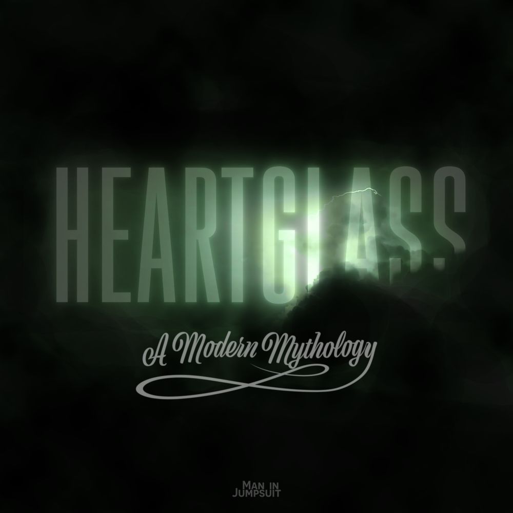 The show card for Heartglass. Illuminated green text appearing from dark storm clouds which reads "Heartglass."

Beneath it is the tagline "A Modern Mythology" in a flowing gray script with a long flourish on the tail of the Y.

Faintly at the bottom is the text logo of the production studio "Man in Jumpsuit"