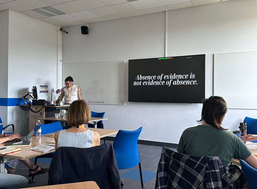 A person presenting with a slide that reads Absence of evidence is not evidence of absence.