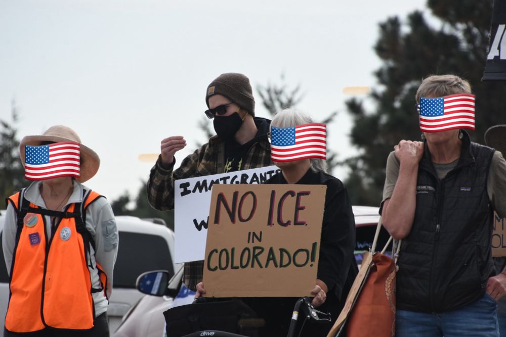Protesters with signs. One reads NO ICE IN COLORADO!
