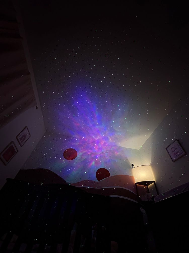 A picture of the ceiling of a child’s bedroom with the twin suns from Star Wars’ planet Tatooine as well as Star and astral projections on the walls 