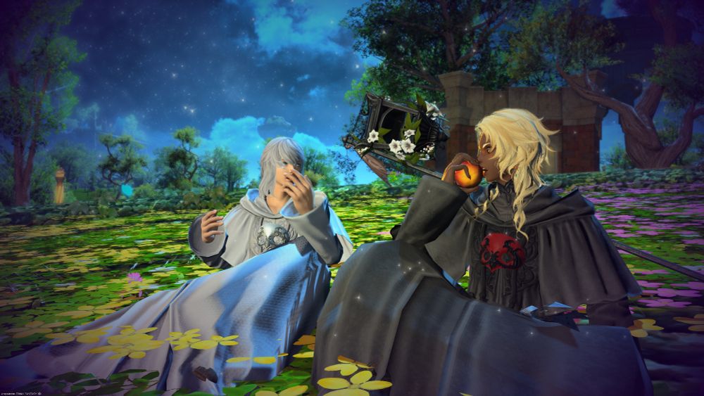 Two friends chat and eat in the cool moonlight