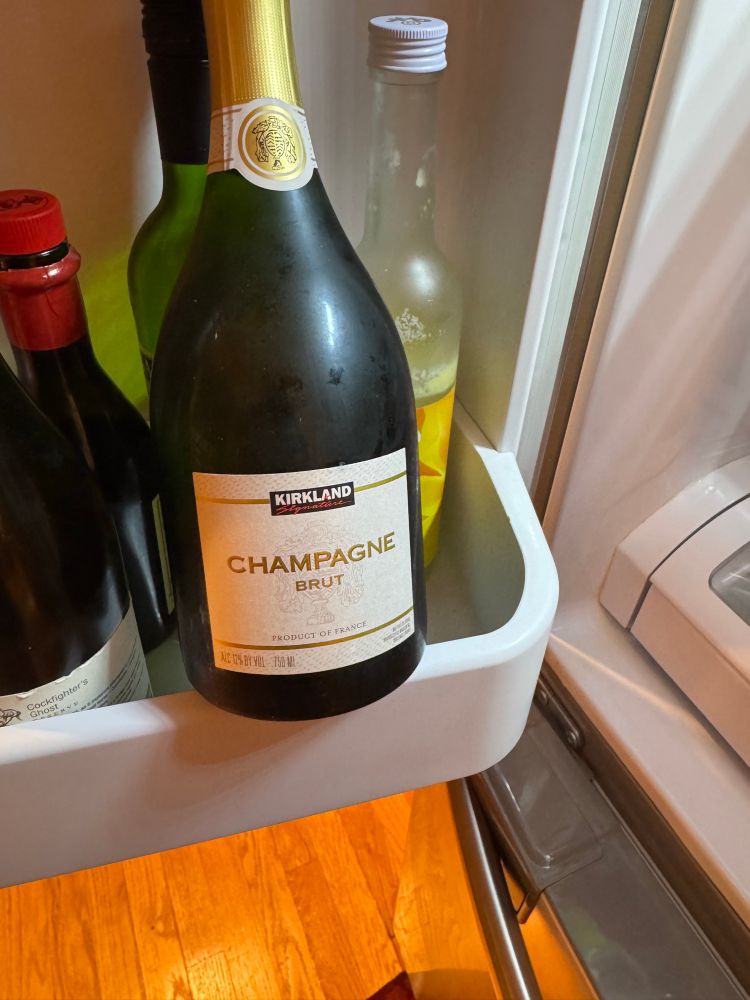 Bottle of Kirkland champagne in the fridge. But it’s real champagne, ready for the occasion 