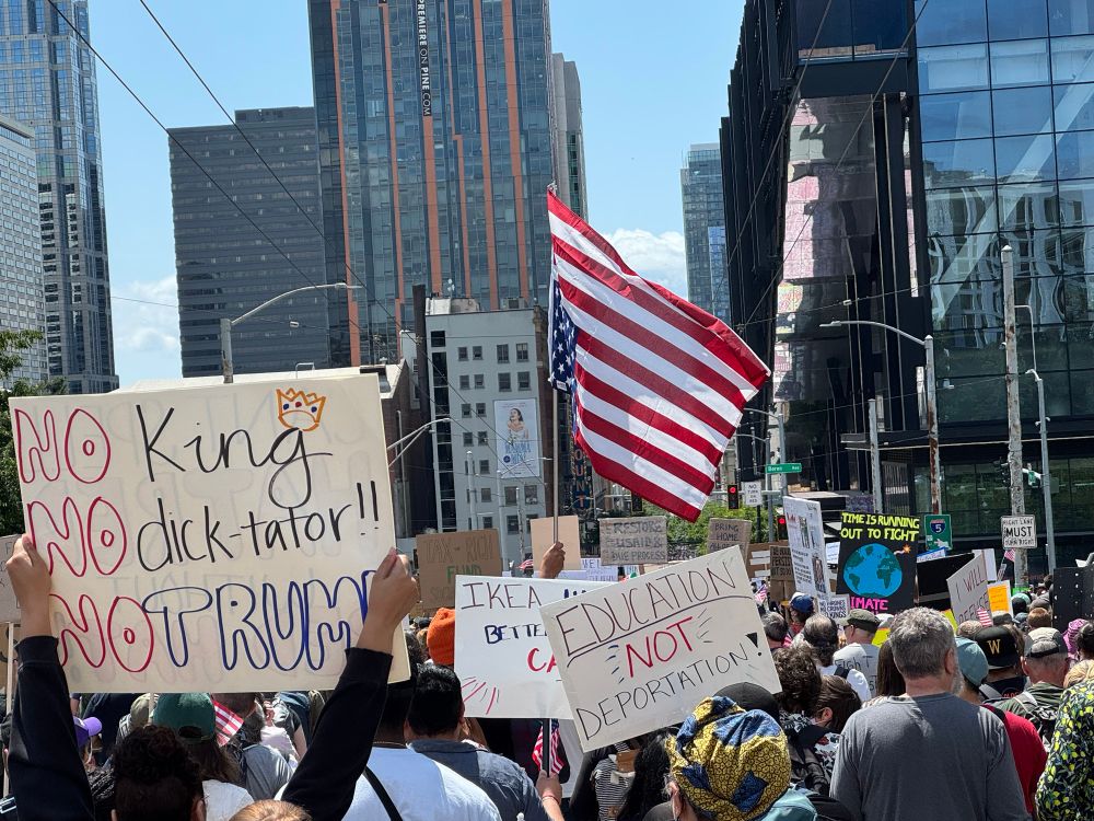 NoKings attendees marching down Pine St in Seattle 