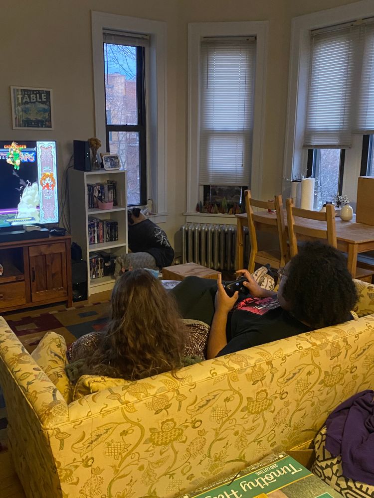 Grace and Sibye on a couch playing Guilty Gear.