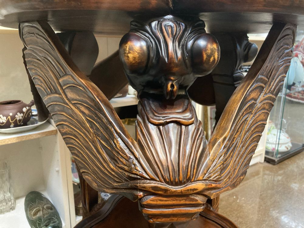Table leg carved to look like dragonfly 