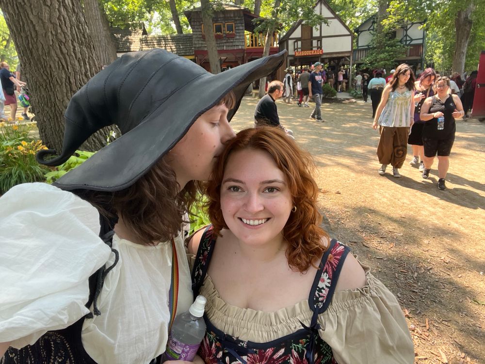 Dani kisses Izzy on the head while taking a selfie 