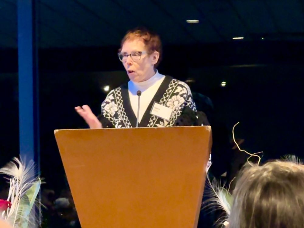 Photo of Nora Disis speaking after receiving the award. 