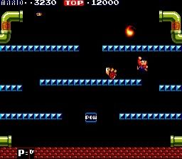 Mario is about to knock out an overturned koopa in the original Mario Bros, which was just three layers of blocks plus a few pipes where baddies or I guess fireballs came out.