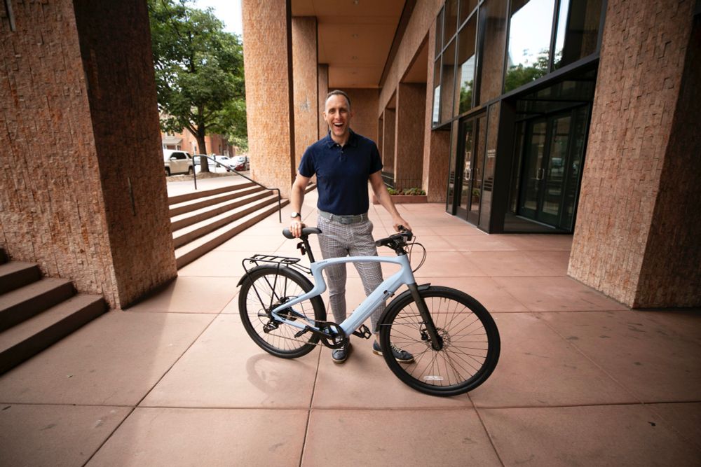 Ryan stands with his new powder blue e-bike 