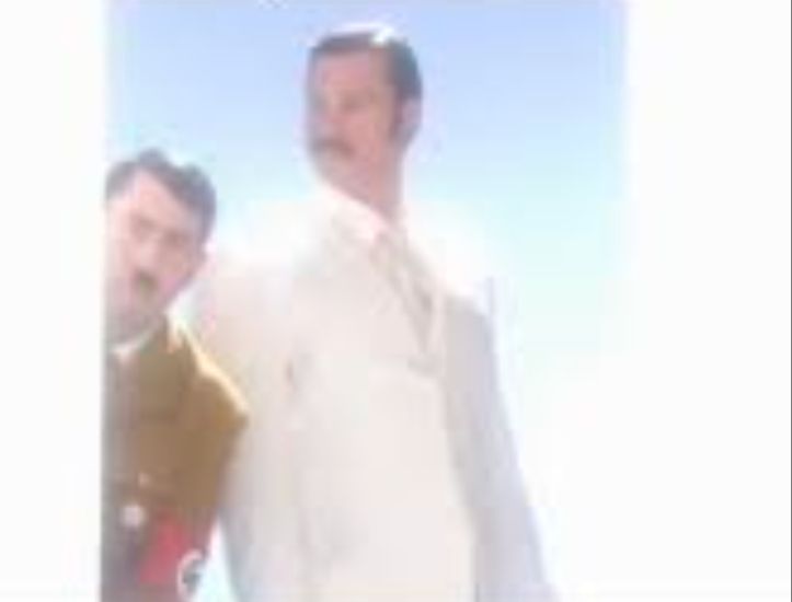 Hitler hiding by man in white suit
