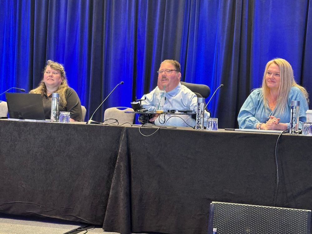 A panel of guest speakers are on stage at the NCIL conference. Serra Rey, Russel Dawson-Rawlings and Jennifer Griffen giving a DDAR Disaster Prep session to conference attendees.