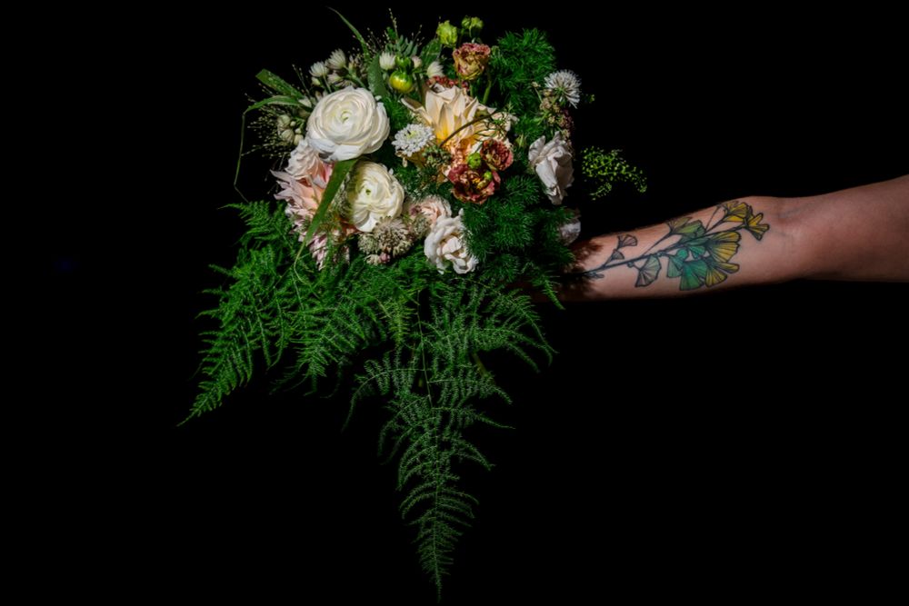 a photo of a wedding bouquet with some neutral flowers and a lot of ferns & greenery
