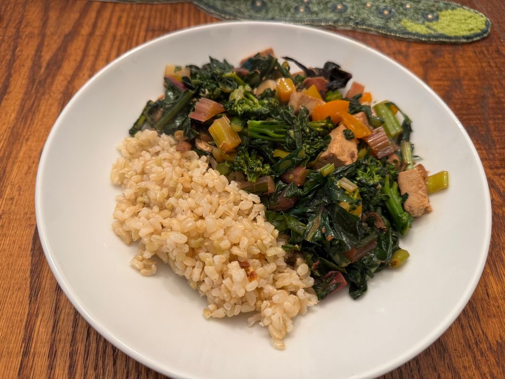 a picture of a plate of food that's about 1 quarter rice and 3 quarters vegetable stir fry