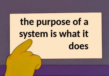 yellow, four-fingered “The Simpsons” hand pointing at a sign reading: the purpose of a system is what it does
