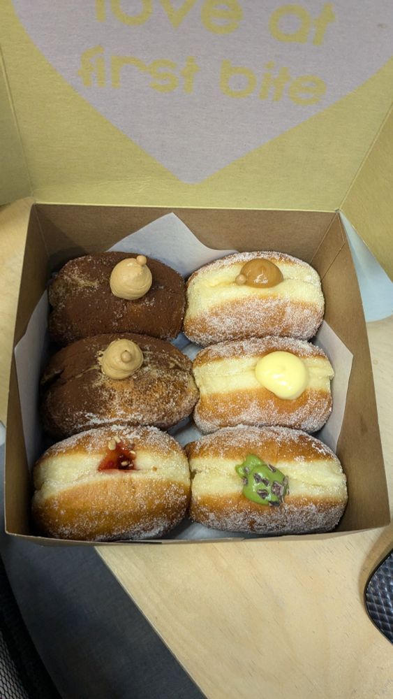 Box of 6 donuts stood up on their side 
