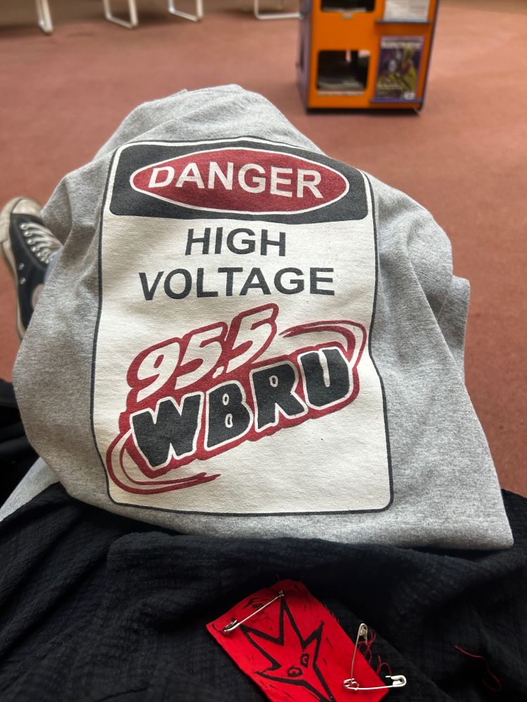 T shirt for 95.5 WBRU radio station says "Danger High Voltage" like a warning sign near electric wires