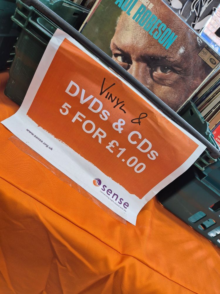 Sign showing 'Vinyl & DVDs & CDs, 5 for £1'