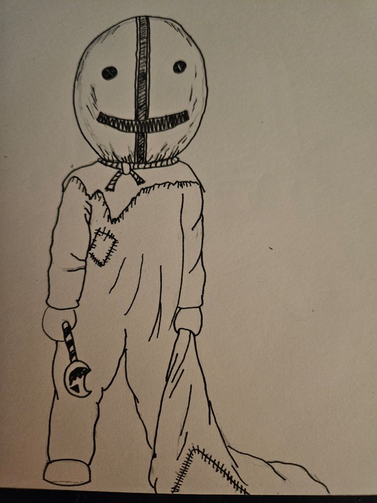 A scary child in a sack mask carrying a sack and a sharp lolipop