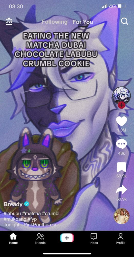 Fake tiktok screenshot of my fursona, and black and white anthro cat, holding a cookie into the camera. On the cookie is a little chocolate figure in the shape of a labubu. Text on the image says "eating the new matcha dubai chocolate labubu crumbl cookie". 