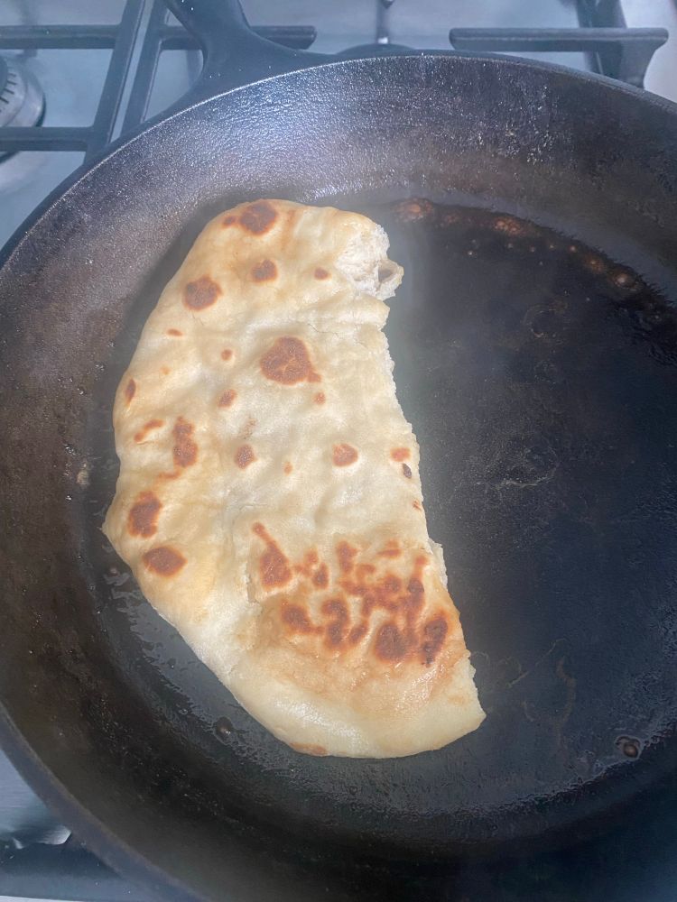 homemade naan in cast iron skillet