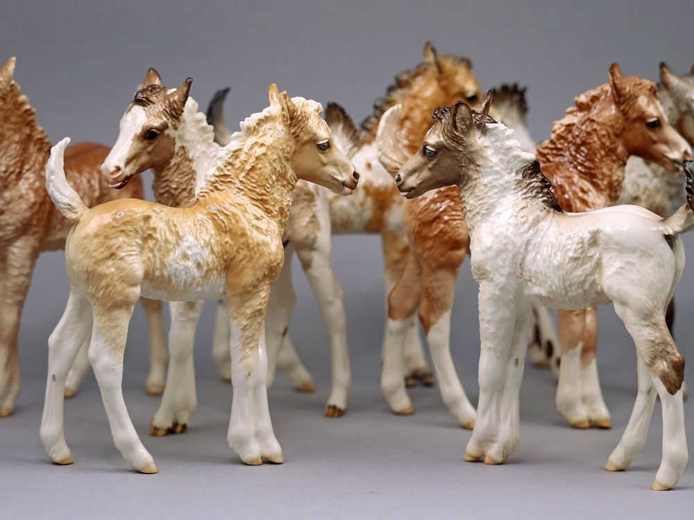 A group of earthenware ceramic foals of different colors