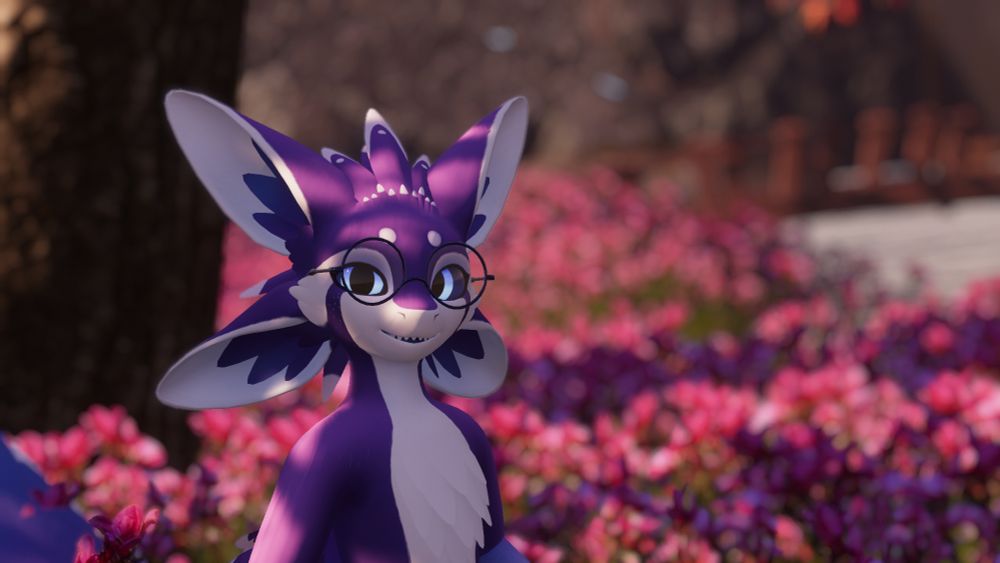 A purple avali smiling at the camera in front of pink flowers