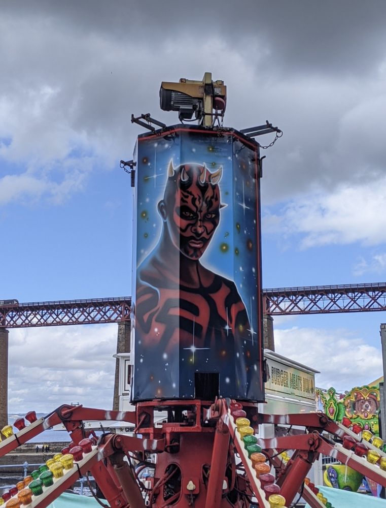 A photo of a weirdly sexy topless Darth Maul painted on fairground ride