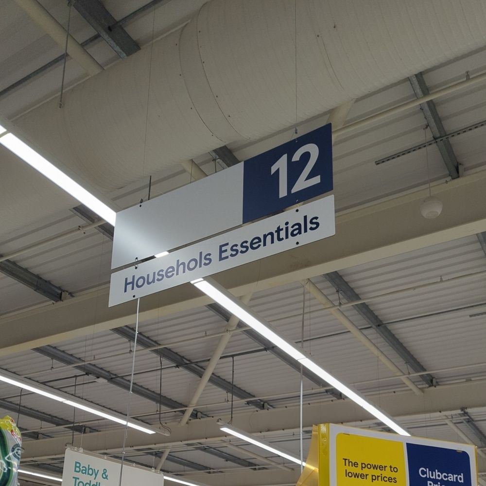 A photo of an aisle sign in Tesco which reads "Househols Essentials". Not a typo. Well, not my typo. 
