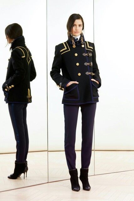 Woman wearing a high-fashion military dress uniform-style outfit, only missing the Char mask