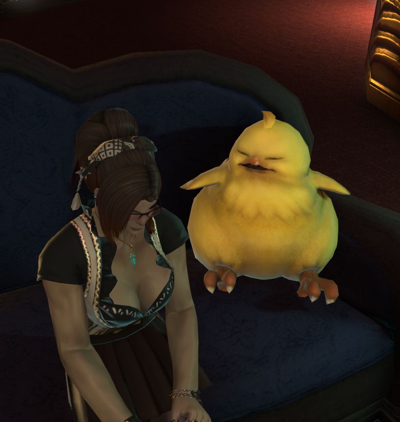 a woman sitting on a couch next to a chubby yellow bird