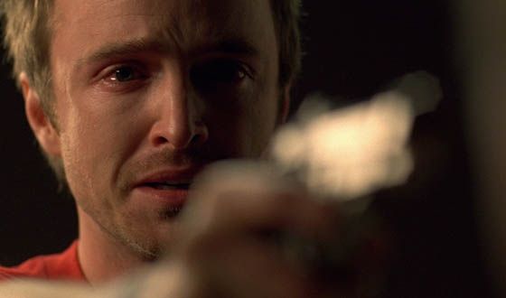 Jesse Pinkman (Aaron Paul) pointing a gun at someone off camera. It's a close-up with tears in his eyes.