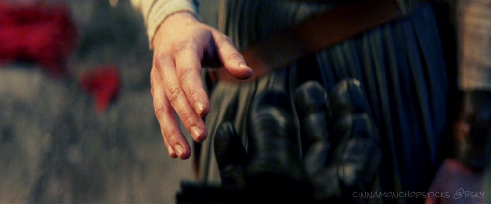 Rey reaches out as she considers taking Kylo's hand in The Last Jedi.