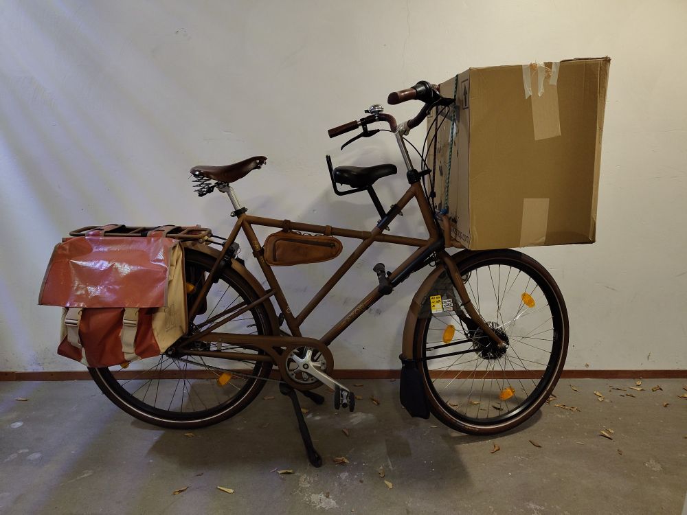 A modern Dutch transporter bike with a large box on the front carrier.