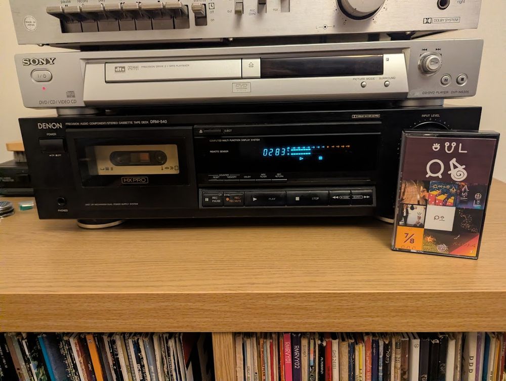 The same cassette deck as in the previous photo, playing "kalama musi pi jan Usawi". The tape box and labels are written in sitelen pona.