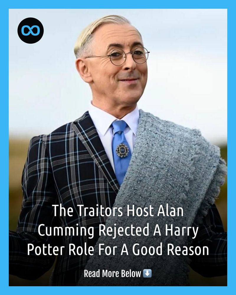 A promotional shot of Alan Cumming, host of The Traitors, who is fair-skinned with a very light blonde comb over hairstyle, wearing round wire-rimmed glasses, a blue-toned tie with a floral-shaped piece of jewelry in the center, and a black suit with a dark blue plaid pattern. A gray fuzzy throw is across his shoulders. Cumming is turned slightly left, looking towards the right side of the image with a sly smile. The image is framed in a bright blue border with a black circle containing a white infinity symbol in the upper left corner. In the bottom half of the image, in white text, are the words, 