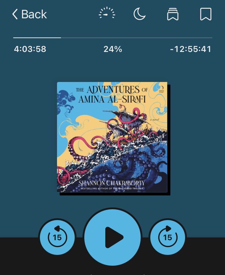 A screenshot of an audiobook playing in the Libby app. The book is called The Adventures of Amina al-Sirafi. The cover art is nautical, with giant octopus with arms entangled with a sailing ship. 