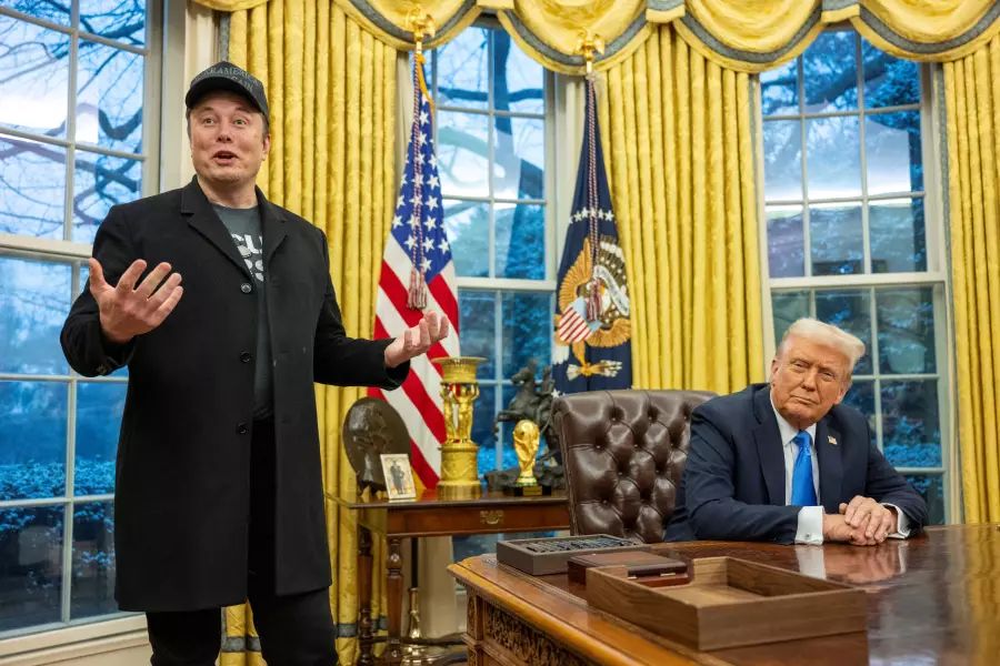 Elon Musk, an ex officio member of the US government, standing next to the Oval Office desk where President Trump sits - our reality in February 2025 