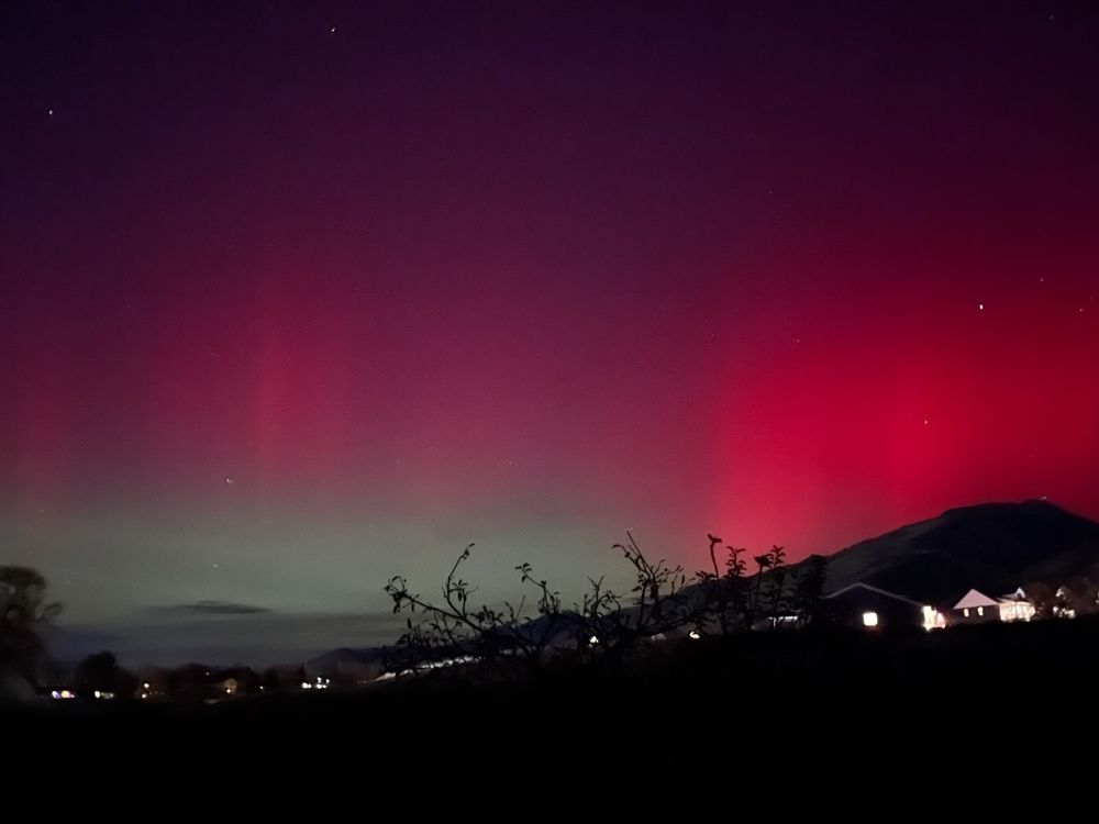 A dramatic red and green aurora