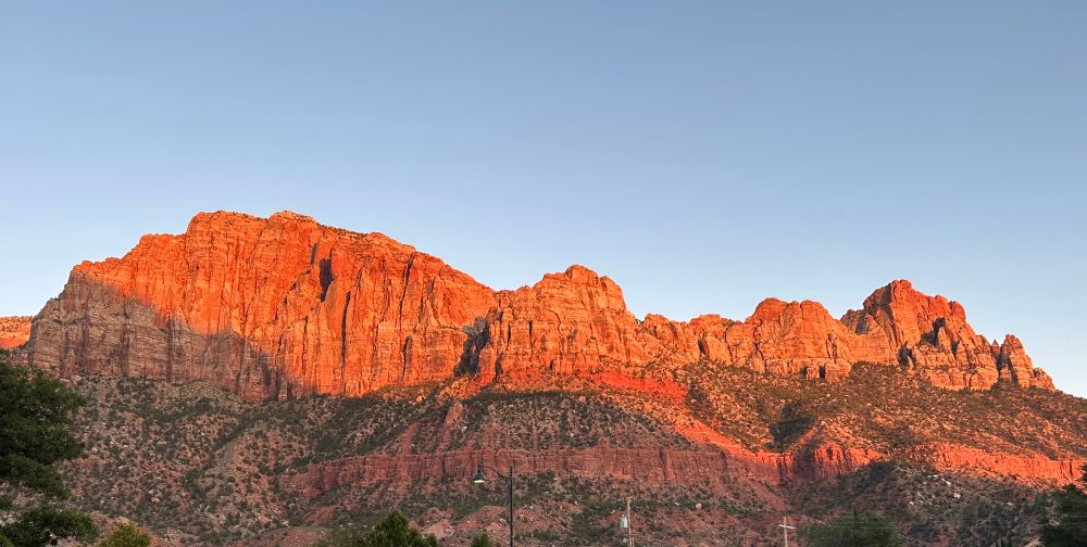 Sunset lighting up red rocks in Springdale, Utah