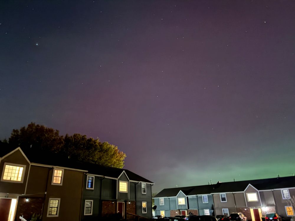 The northern lights visible over an apartment building 