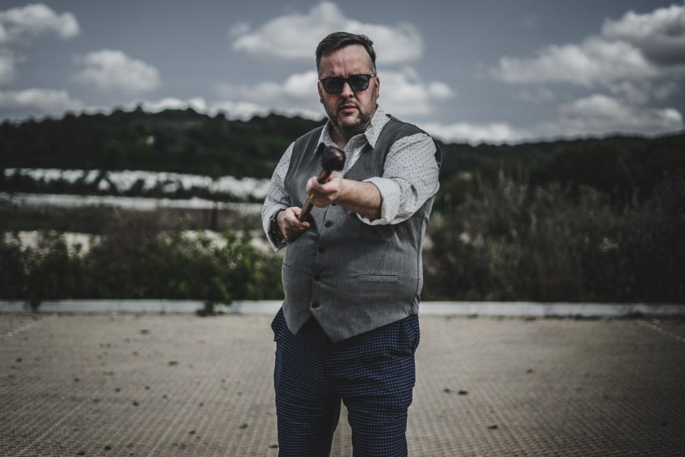 Ulyssess M. Barnes pro wrestling manager Holding his cane towards the camera