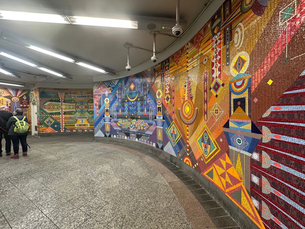 Very colorful murals with geometric / cosmological patterns — same for all four photos 