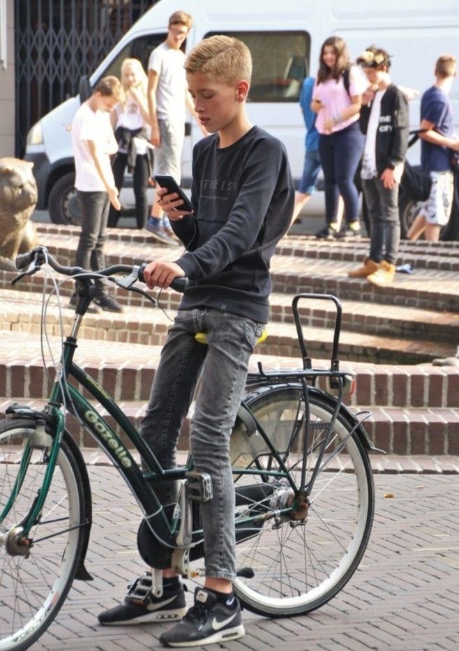 Young male bicyclist looking at his smartphone